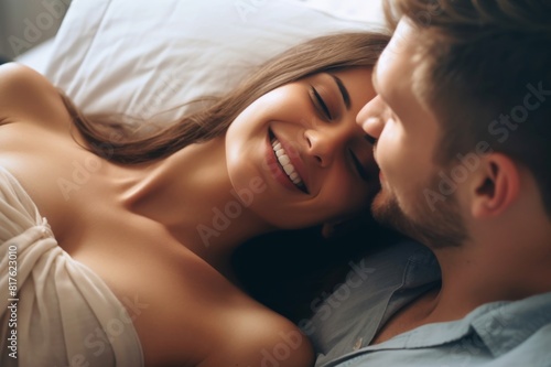 Cropped shot of an affectionate young woman smiling at her husband while lying in bed at home
