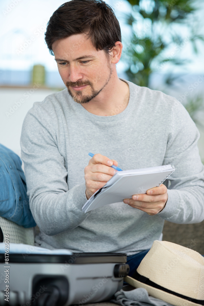 man writing a list before travelling man writing a list before travelling