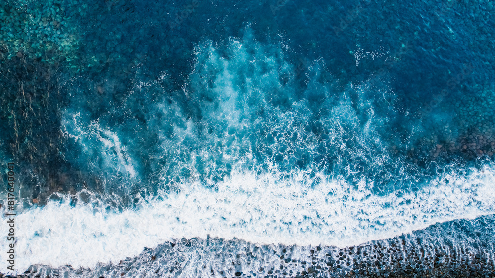 Aerial view of rough ocean with waves, volcanic beach in Ponta do Sol, Madeira, Portugal
