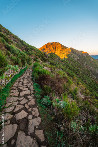 Hiking on the highest peak of Madeira Pico Ruivo next to the cottage Abrigo do Pico Ruivo. Views of the surrounding mountains lanscape during sunrise