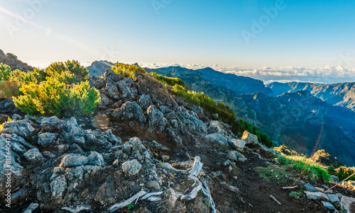 Hiking on the highest peak of Madeira Pico Ruivo next to the cottage Abrigo do Pico Ruivo. Views of the surrounding mountains lanscape during sunny day