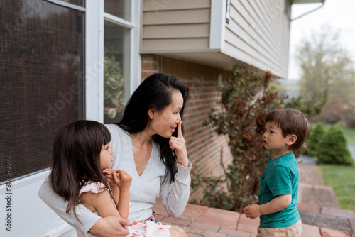 Mother with children outside in suburbs photo