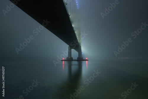 The eerie glow of the Verrazano Bridge on a hazy night in NYC photo