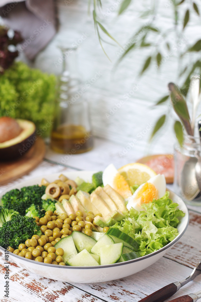 A bowl with a salad made of green vegetables A bowl with a salad made of green vegetables