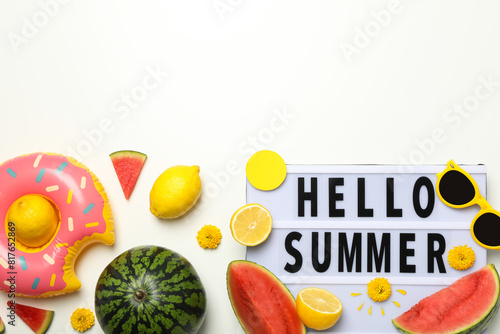 Sign hello summer with fresh fruits and glasses photo