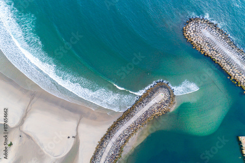 Aerial zenithal view of a groyne on a beach  breakwater for harbor protection