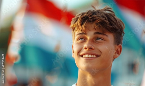A young smiling man on the background of the Belarus flag. Happy Belarus Independence Day. Greeting card, banner, poster, flyer.
