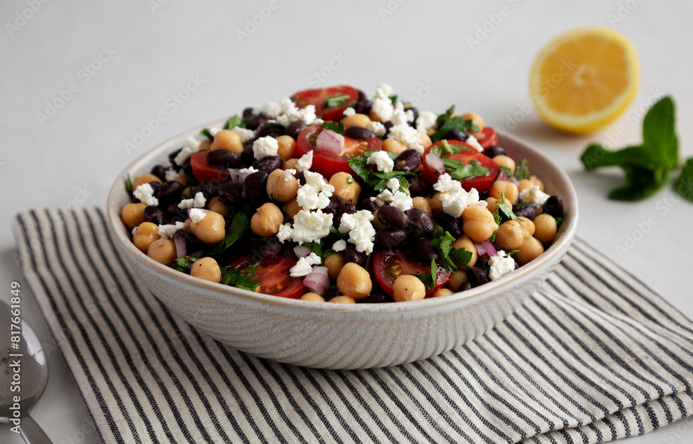 Homemade Chickpea And Black Bean Salad in a Bowl, low angle view. Homemade Chickpea And Black Bean Salad in a Bowl, low angle view.