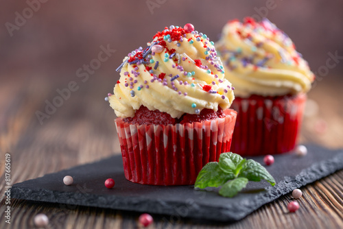 Red velvet cupcakes in colorful setting.