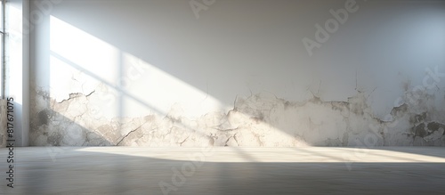 Daylight illuminates an empty room with cracked walls and floor creating a copy space image