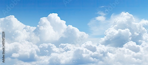 A vibrant blue sky filled with fluffy white clouds providing a perfect copy space image photo