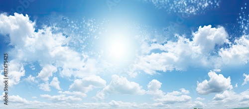 A sunny summer day with blue skies and hole punch clouds creating a picturesque scene The image offers ample empty space for copy photo