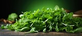 A close up copy space image of fresh green arugula leaves arranged on a table