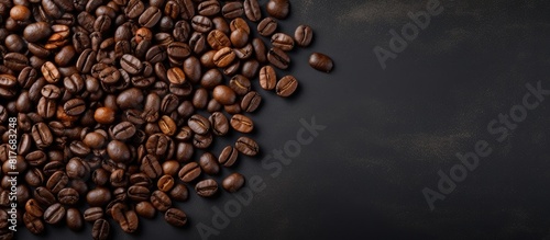 Top view of coffee beans on a dark concrete background providing space for text in the image. Creative banner. Copyspace image