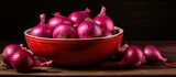 There is a copy space image of a bowl filled with vibrant red onions