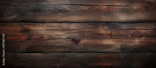 An image of a dark wood texture background with a worn natural pattern providing ample space for copying