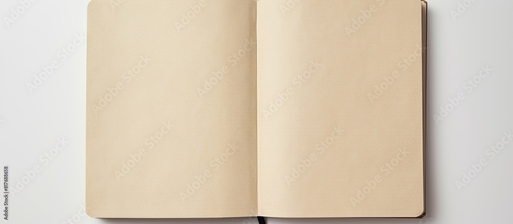 A high angle view of an empty notebook with a recycled paper cover placed on a white background providing ample space for other images A high angle view of an empty notebook with a recycled paper cover placed on a white background providing ample space for other images