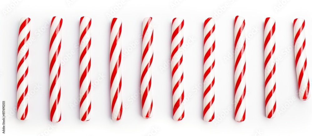 Obraz premium A white background with red and white striped candy canes providing lots of copy space for any design or message you want to add