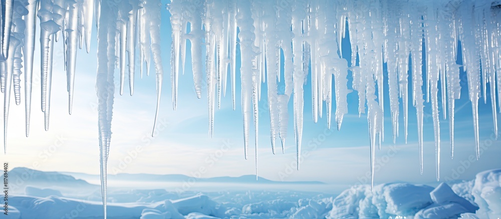 Icicles and snow create a serene winter scene with a copy space image Icicles and snow create a serene winter scene with a copy space image