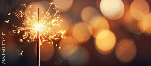 Blurred bokeh light background with a sparkler in the foreground creating a captivating copy space image