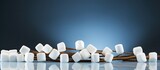 Horizontal photo of marshmallow cubes and sticks placed on a background with ample copy space image on the right