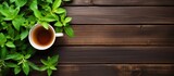 A tea theme with a teapot cup and fresh mint leaves on a wooden background Viewed from above with plenty of space for text or images. Creative banner. Copyspace image