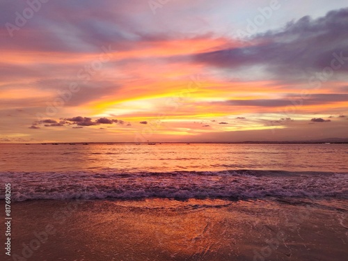 Stunning Sunset Beach Scene with Fiery Red-Orange Sky Over a Tranquil Tropical Sea 