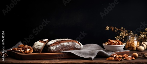 A rustic slate plate with a hessian table cloth showcasing a delicious copy space image of fresh sourdough bread topped with nuts