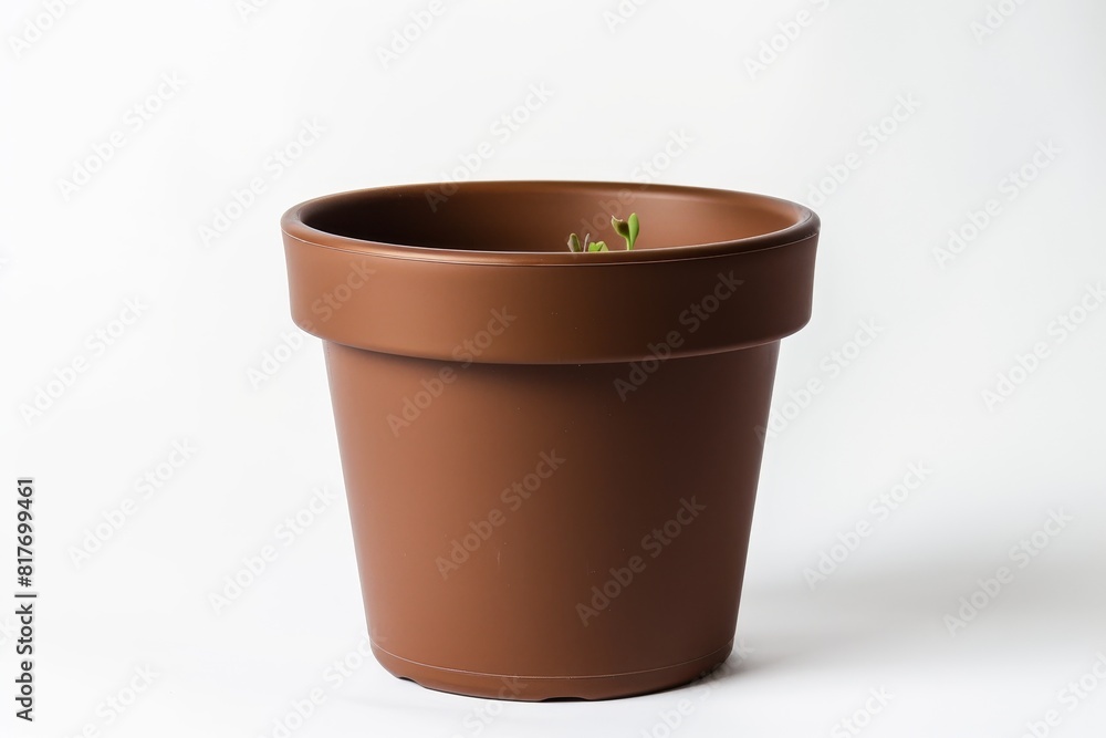 Brown plastic flowerpot on white surface Brown plastic flowerpot on white surface