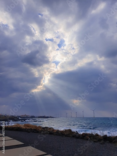 God Rays Through Clouds Over Jeju Island Coastline