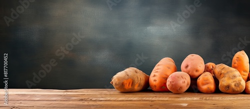 Old wooden table with sweet potato or batat providing ample copy space image photo