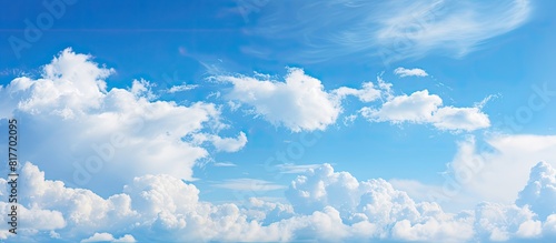 A picturesque blue sky with clouds creates a stunning backdrop capturing the beauty of nature in this copy space image