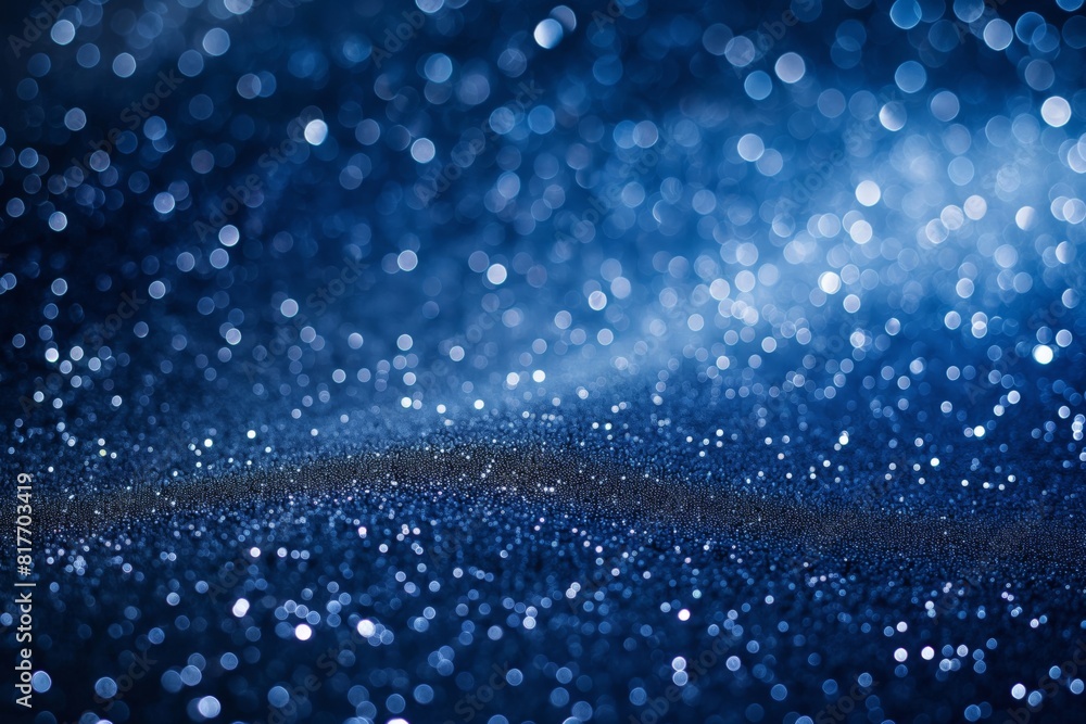 Shimmering and elegant sparkling blue bokeh background with abstract glitter, defocused light, and starry night texture for festive and magical wallpaper pattern for celebration and decoration