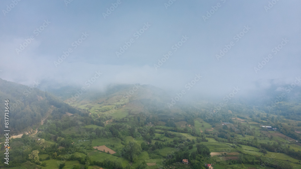 Landscape panorama using the Mini 2 drone, during a foggy morning. Beautiful green land and meadows.