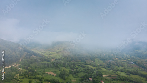 Landscape panorama using the Mini 2 drone, during a foggy morning. Beautiful green land and meadows.