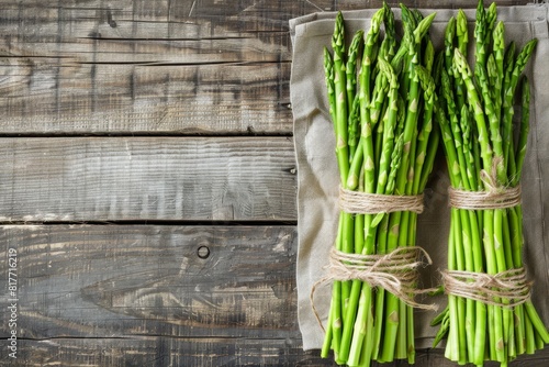 Fresh pickled green asparagus on wooden table Image