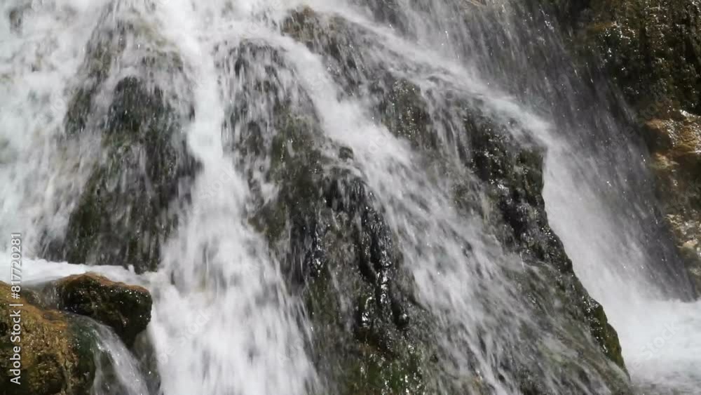 Falling water of a mountain river among stones. Falling water of a mountain river among stones.