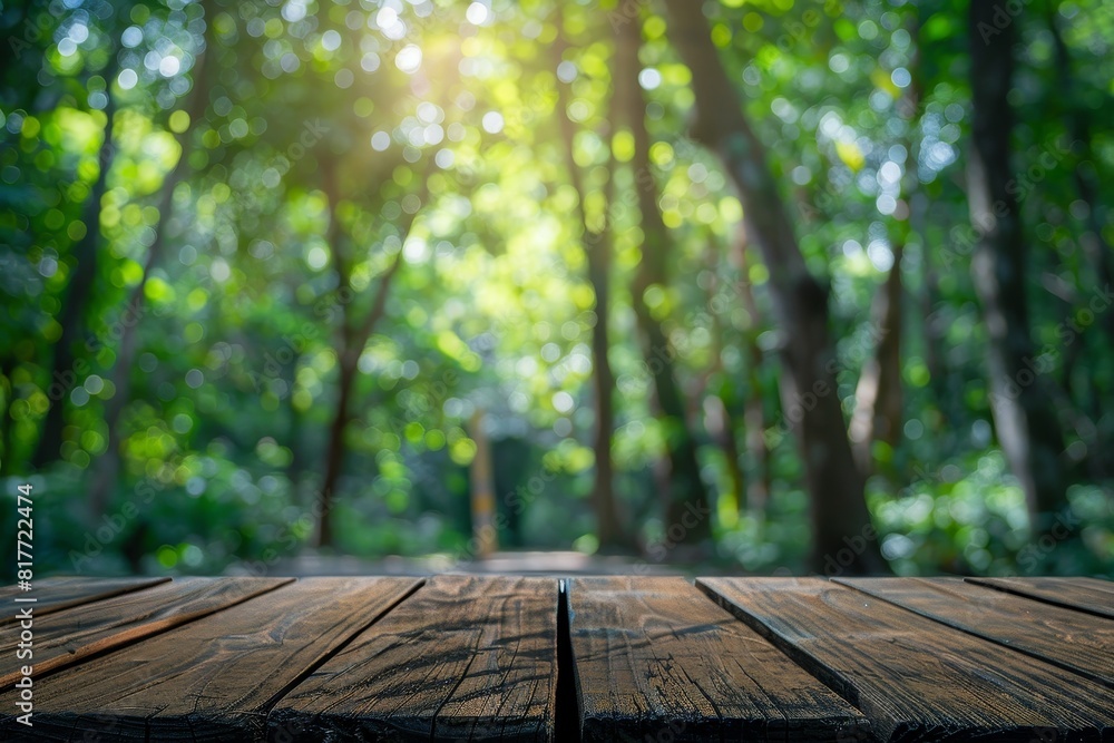 Wooden tabletop surrounded by forest trees with blurred background for product display Wooden tabletop surrounded by forest trees with blurred background for product display