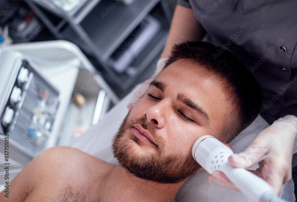 Closeup of face of beautiful relaxing man undergoing hardware cosmetology procedure in spa Closeup of face of beautiful relaxing man undergoing hardware cosmetology procedure in spa