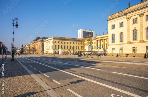 Clear blue sky over Humboldt University and Unter den Linden Street in Berlin, with pedestrians and bicycles. Berlin, Germany
