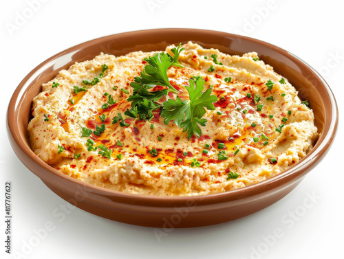 A bowl of hummus with parsley and red pepper flakes