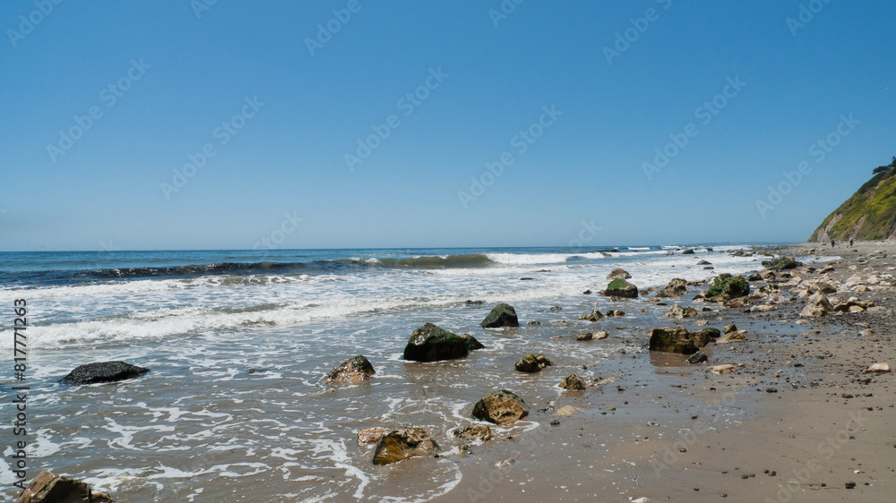 Fototapeta premium Arroyo Burro Beach, Santa Barbara, features rocks in the sand