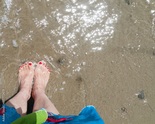 Earthing at the beach with bare feet in the wet sand. Earthing or grounding is an alternative health benefit that grounds people to the Earth to balance energy