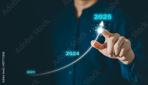Businessman hand drawing arrow line with increasing direction from year 2023 to 2024 to 2025 for forecasting of business plan growing in long term, Happy New year with business growth plan concept