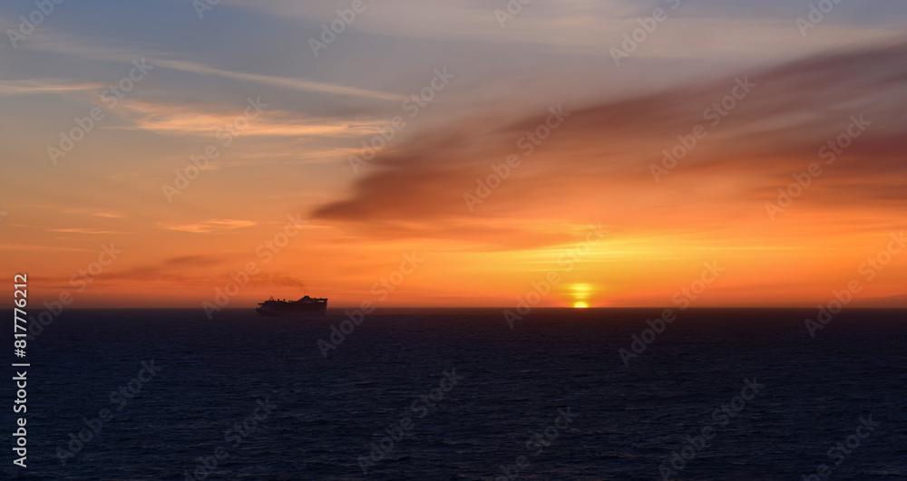 Silhouette image of a cruise ship sailing at sunset. Alaska. USA.