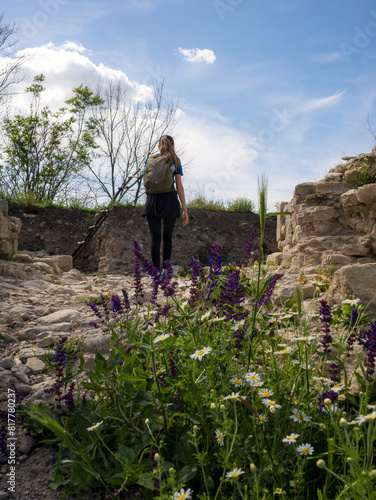 Pretty tourist woman with backpack at the ruins of ancient fortress near Varna Bulgaria