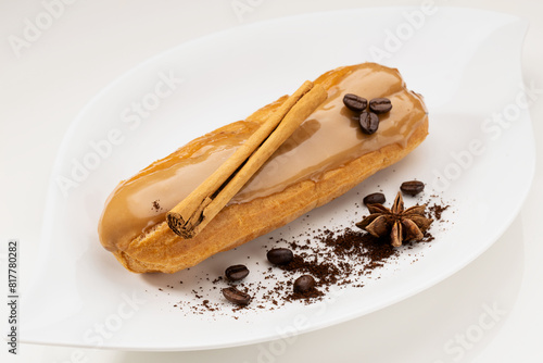 Canvastavla Delicious coffee-flavored eclair dessert decorated with coffee beans and cinnamo