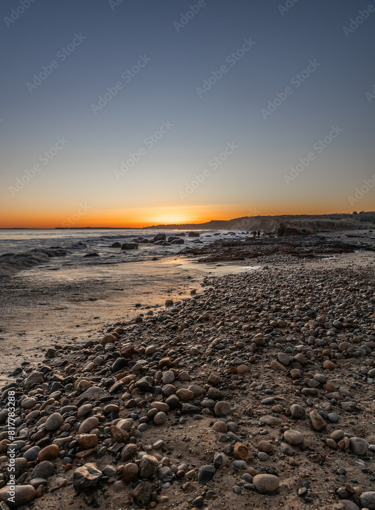 Stunning sunset over the rocky beach and serene ocean. Martha's Vineyard, Massachusetts Stunning sunset over the rocky beach and serene ocean. Martha's Vineyard, Massachusetts