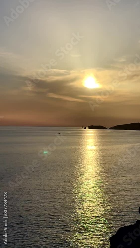 Vertical footage of Cala Tarida Bay at sunset in the island of Ibiza, Balearic islands, Spain photo