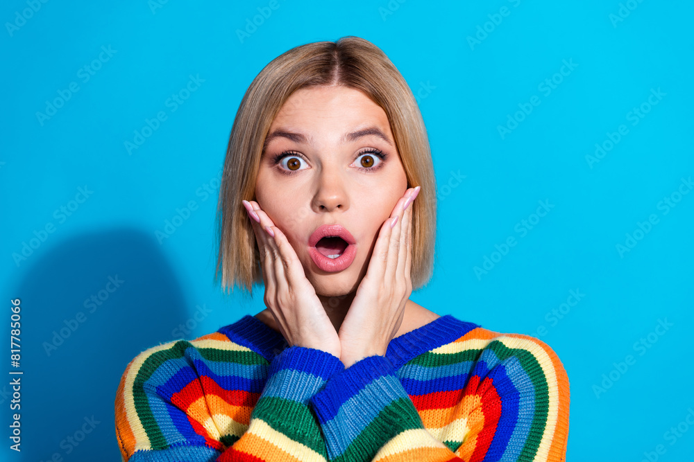 Portrait of pretty young girl staring wear striped pullover isolated on blue color background Portrait of pretty young girl staring wear striped pullover isolated on blue color background